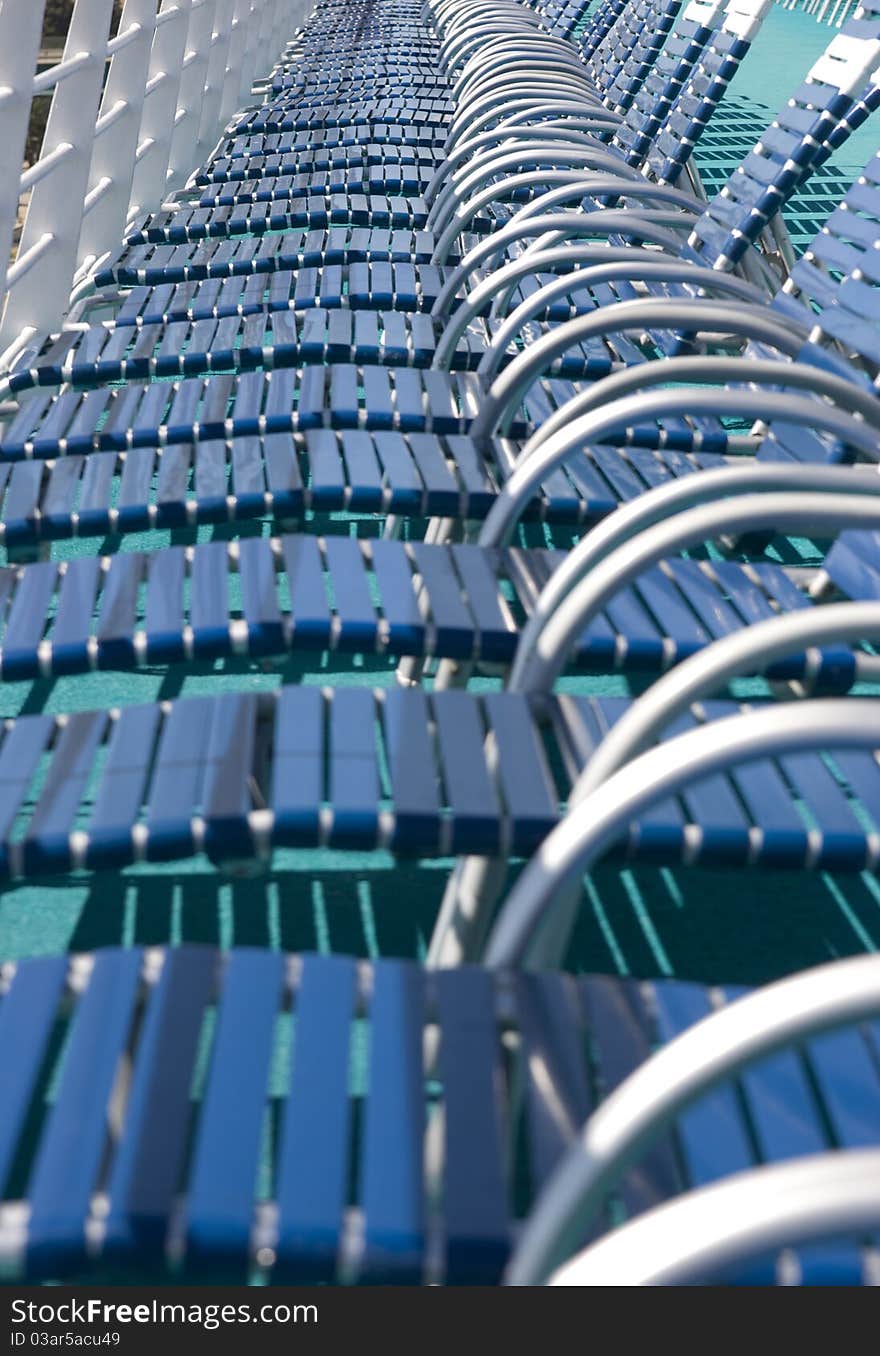 Deck chairs lined up on cruise ship.