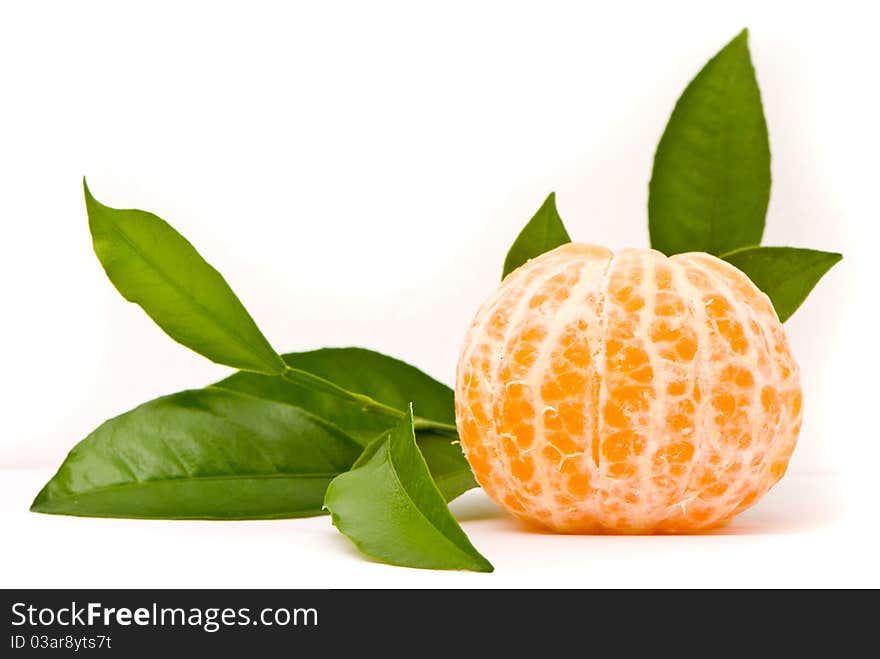 Juicy tangerine and leaves isolated on a white background.