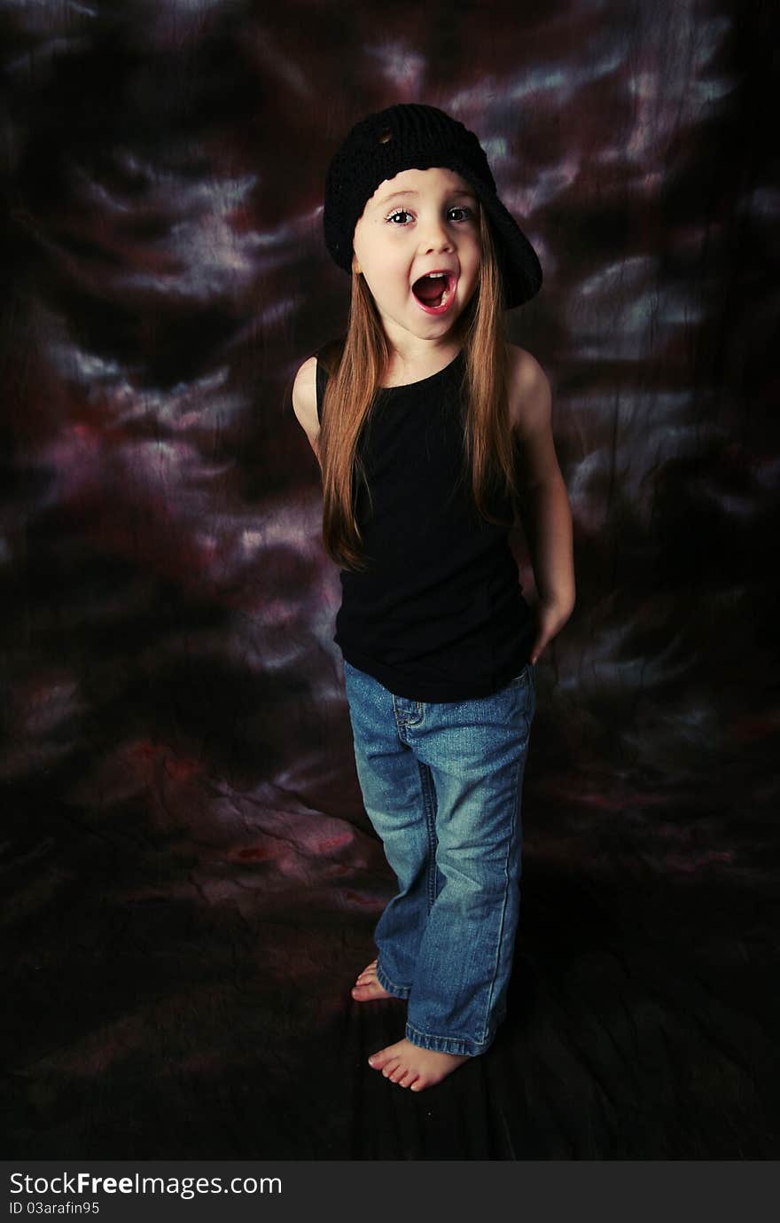 Portrait of a beautiful young female child model wearing a black crochet hat posing. Portrait of a beautiful young female child model wearing a black crochet hat posing