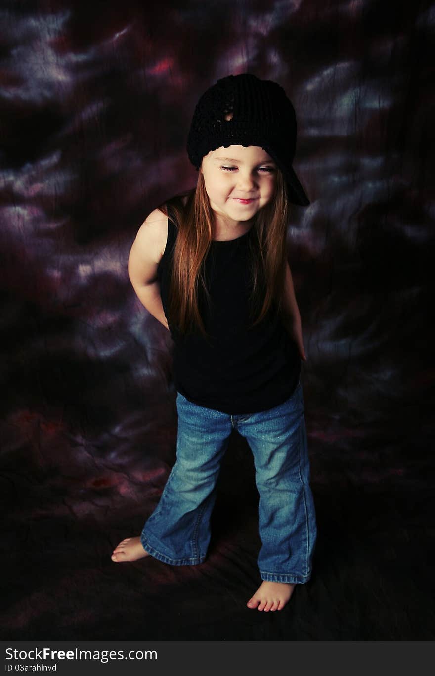 Portrait of a beautiful young female child model wearing a black crochet hat posing. Portrait of a beautiful young female child model wearing a black crochet hat posing