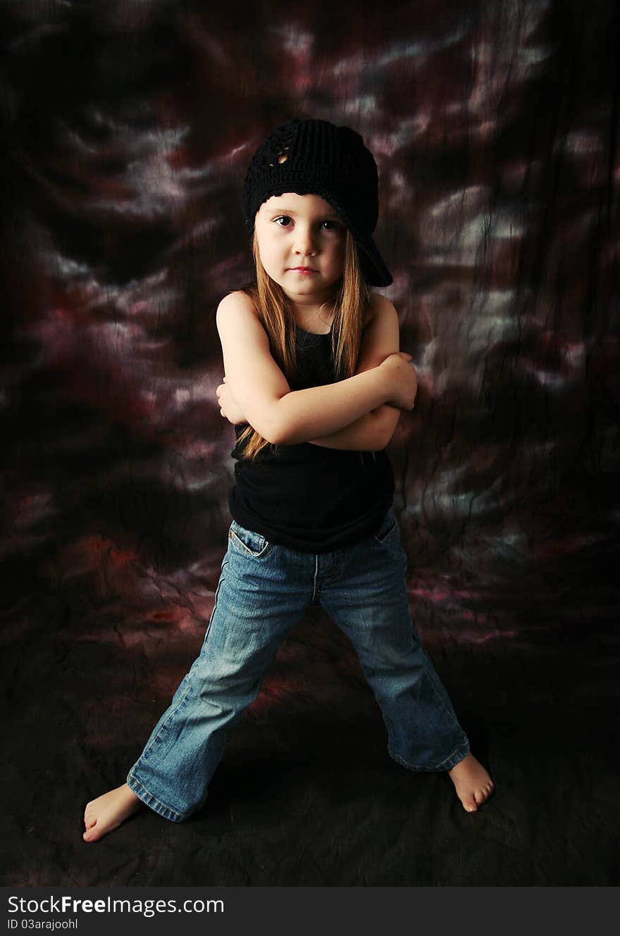 Portrait of a beautiful young female child model wearing a black crochet hat posing. Portrait of a beautiful young female child model wearing a black crochet hat posing