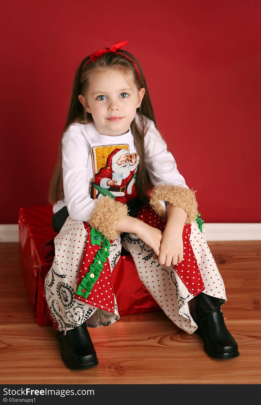 Adorable preschool girl wearing a Christmas holiday outfit posing. Adorable preschool girl wearing a Christmas holiday outfit posing