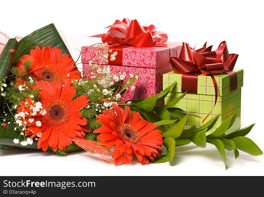 Magnificent bouquet gerbera and present boxes on a white