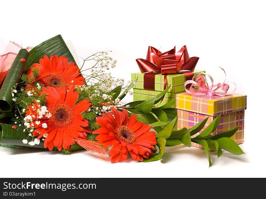 Magnificent bouquet gerbera and present boxes on a white. Magnificent bouquet gerbera and present boxes on a white