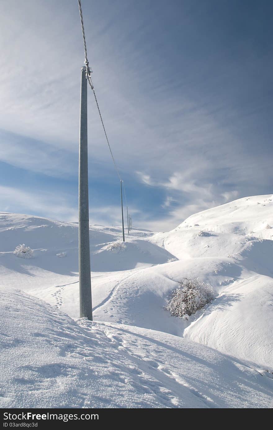 Electricity poles on the snowy mountain