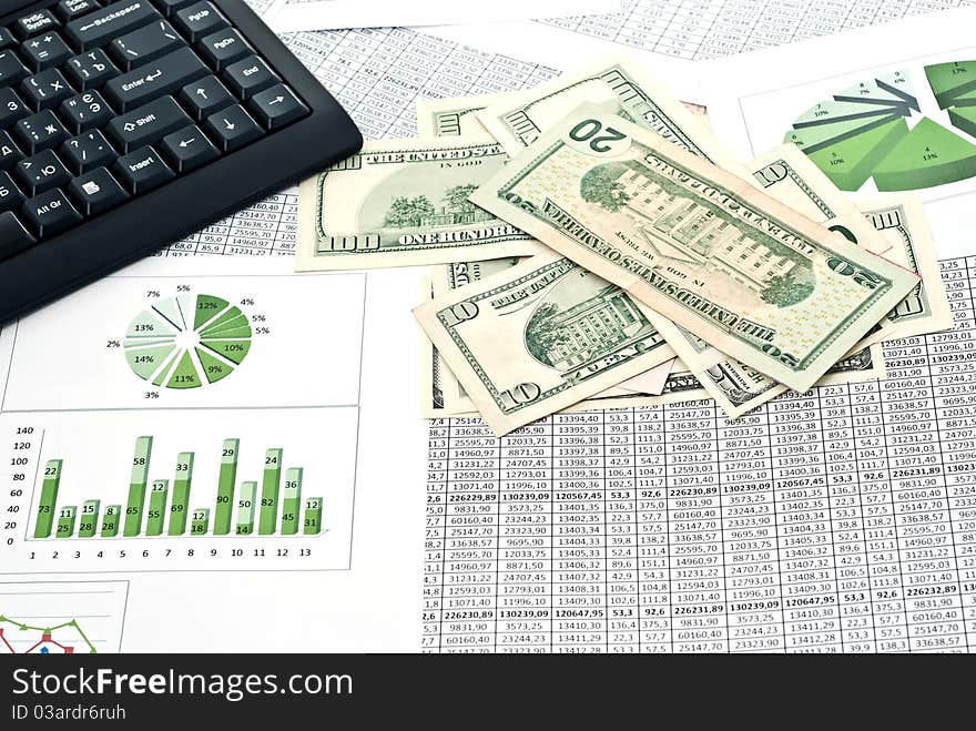 Black keyboard, mouse and dollars on a stock chart. Black keyboard, mouse and dollars on a stock chart