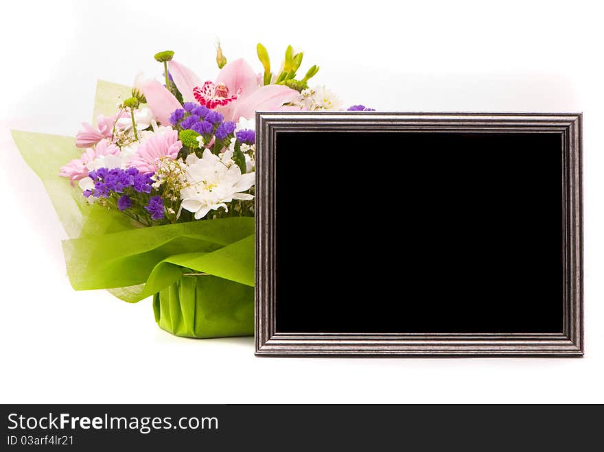 Beautiful bouquet and silver frame on a white