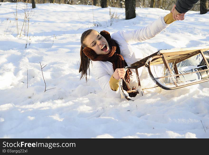 Young joyful woman having accident on sledge. Young joyful woman having accident on sledge