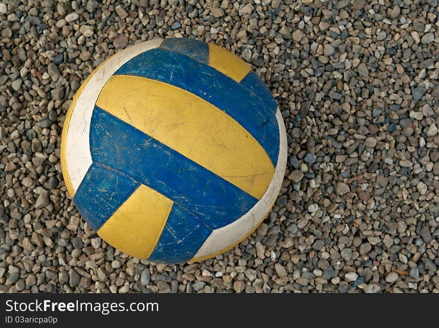 Volleyball on a gravel surface