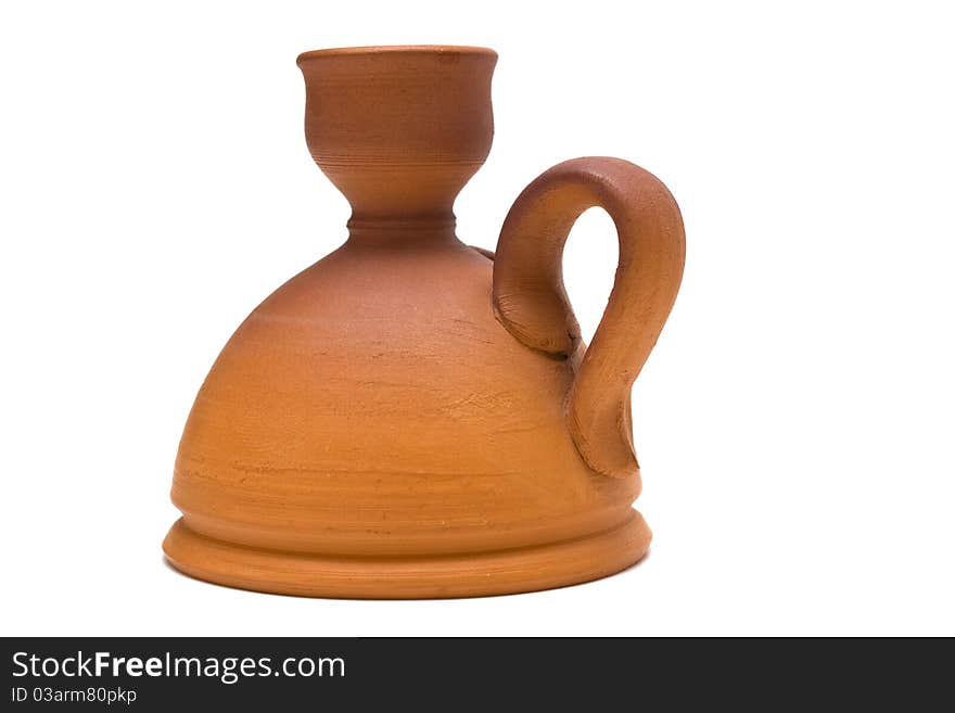 Beautiful ancient pottery candlestick on a white background. Beautiful ancient pottery candlestick on a white background