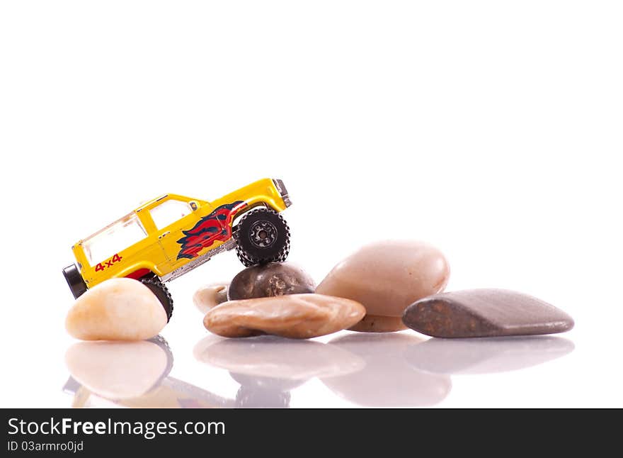 Toy Car Doing an Off-Roading Maneuver on Rocks