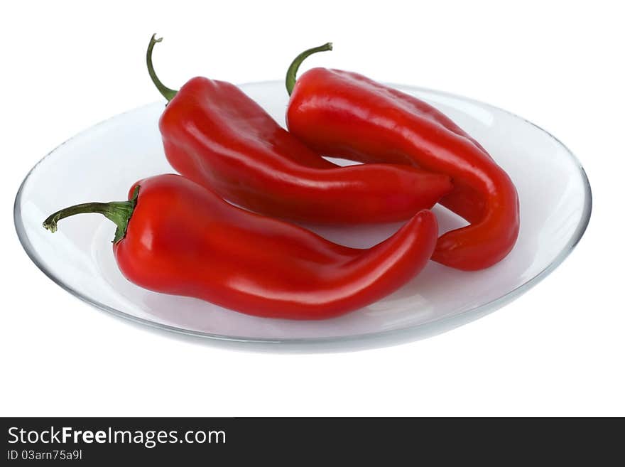 Ripe red peppers on a white background