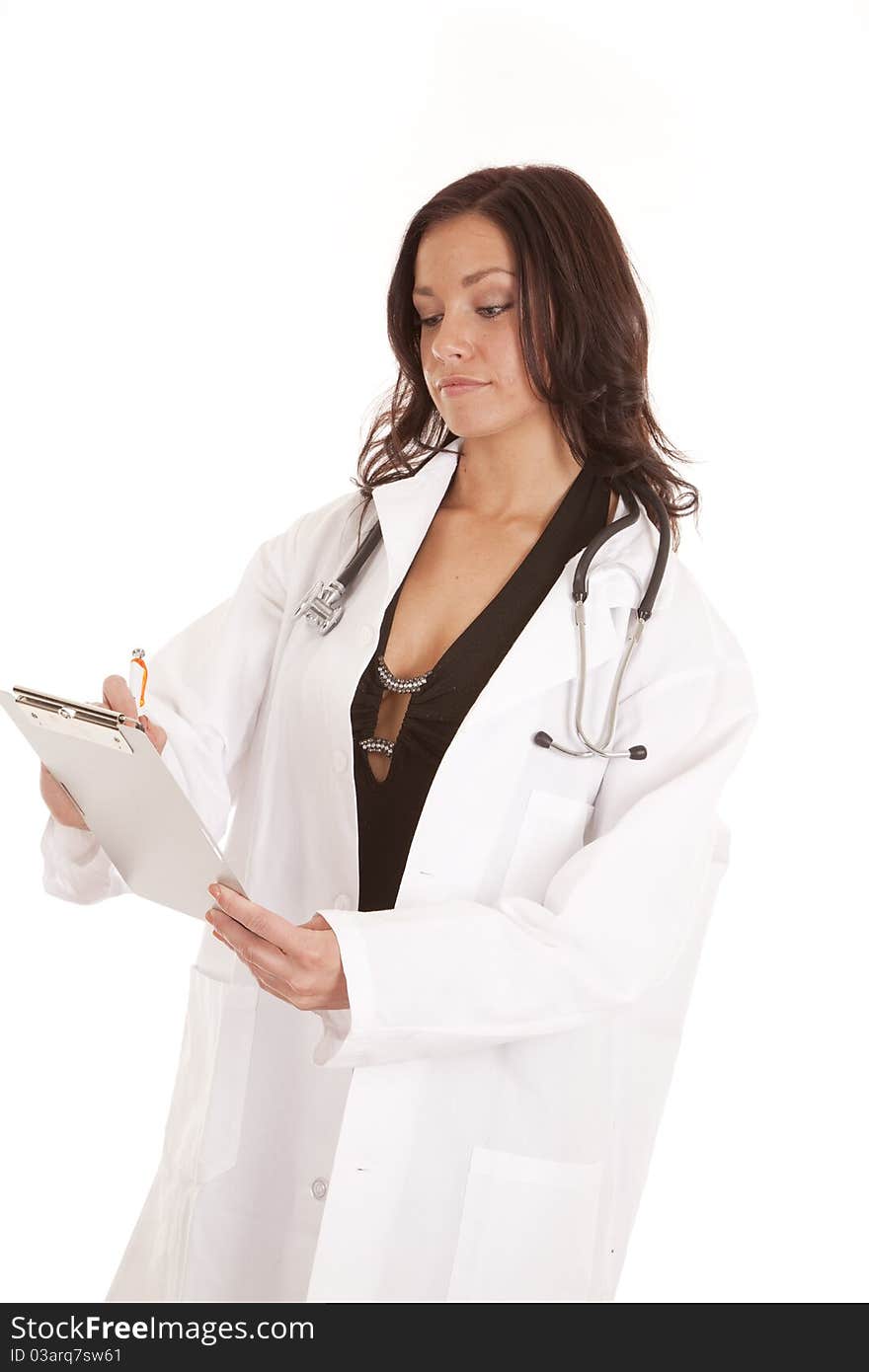 A woman doctor is looking down at a chart writing. A woman doctor is looking down at a chart writing.