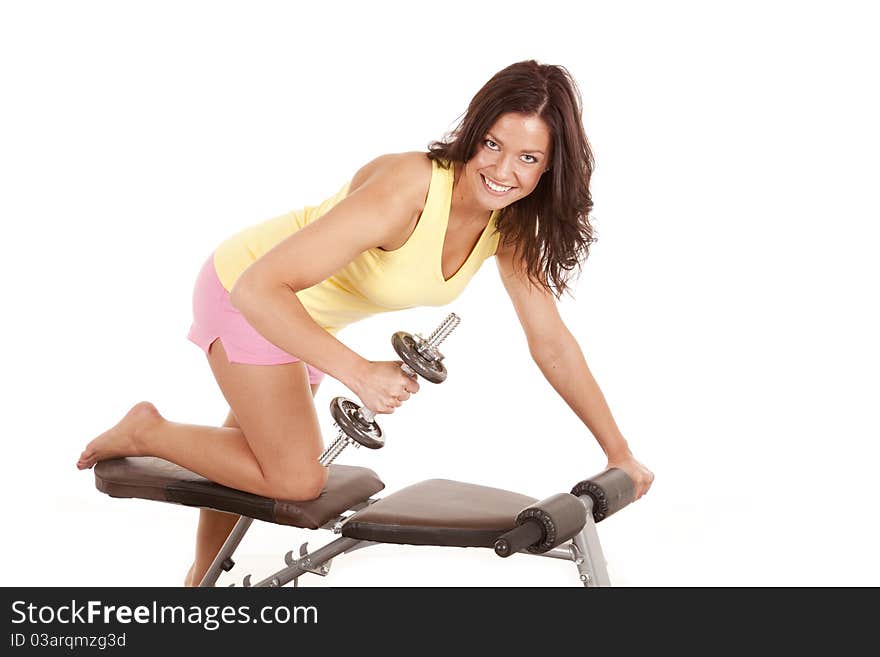 A woman is on a weight bench working out. A woman is on a weight bench working out.