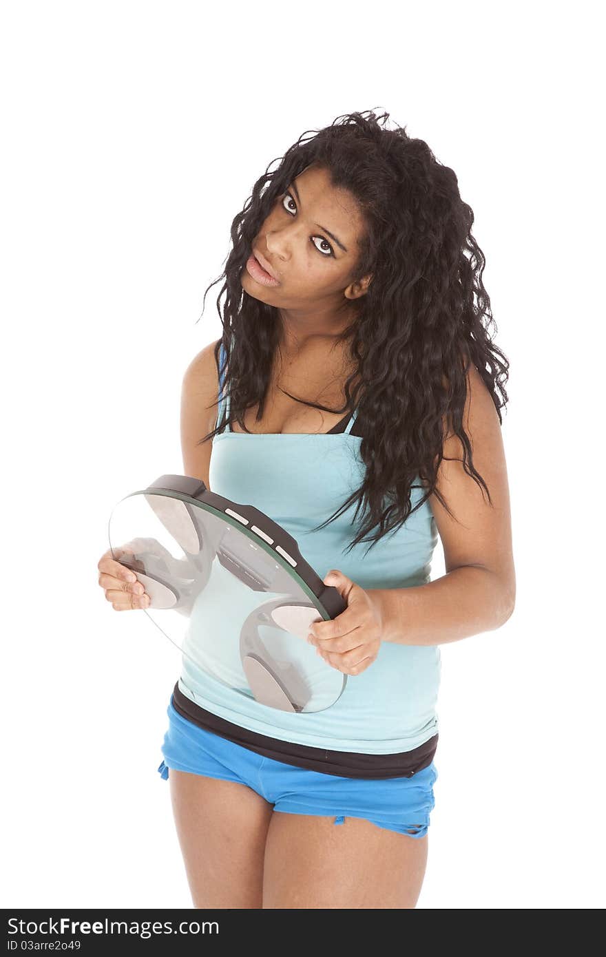 An African American woman is holding some scales. An African American woman is holding some scales.