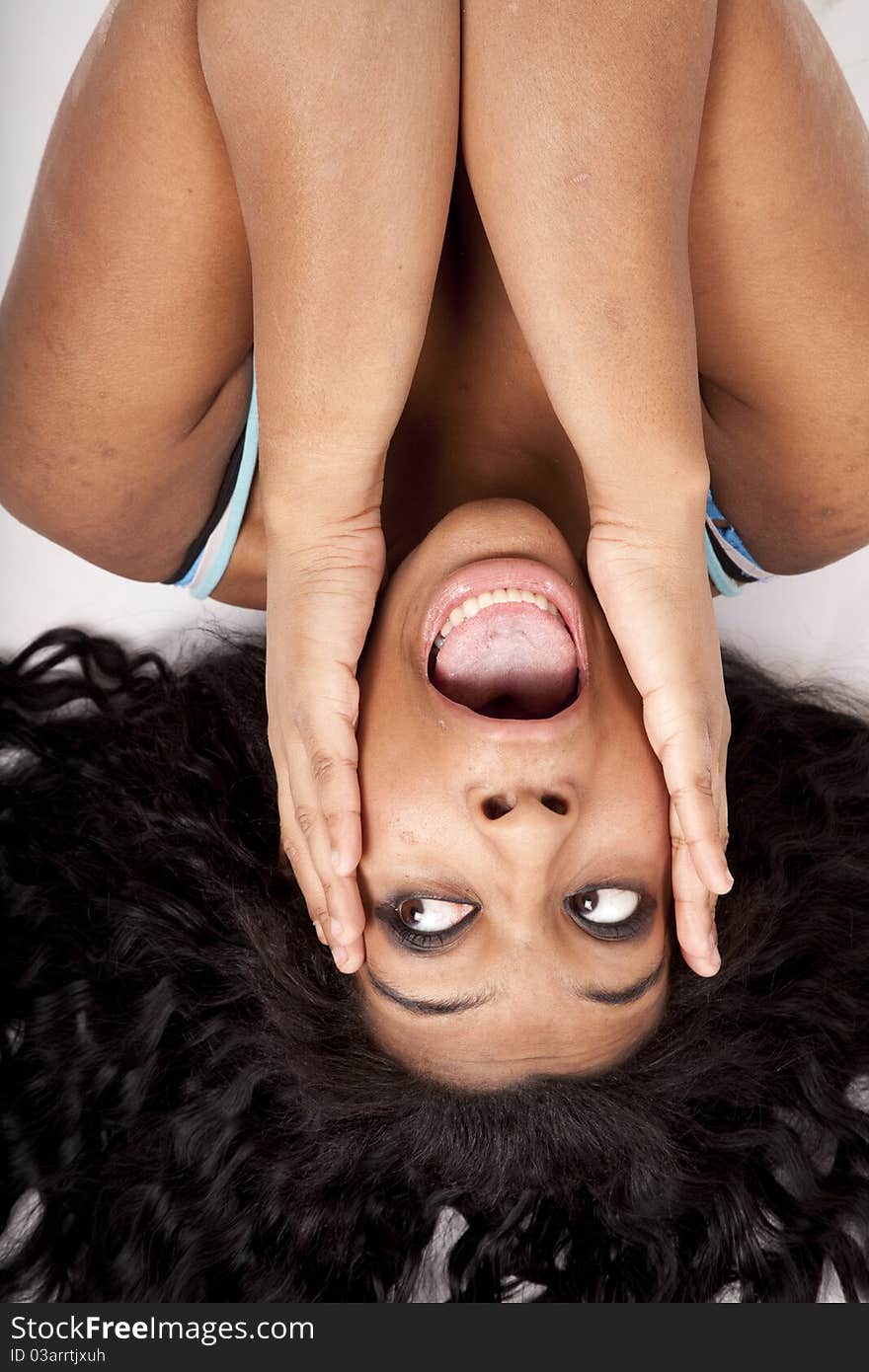 Woman upside down hair out hands face