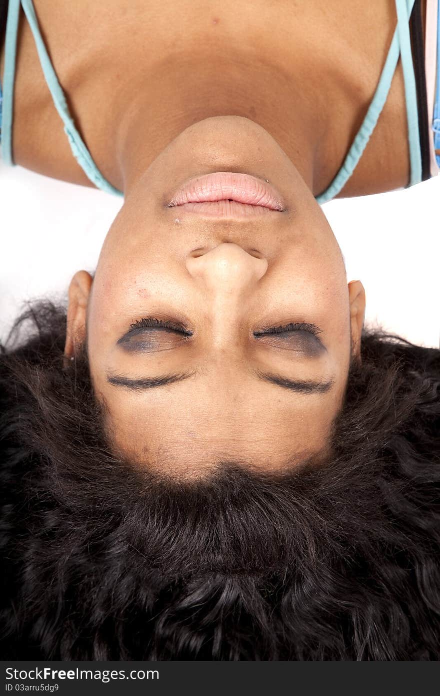 A woman is upside down with her hair fanned out and eyes closed. A woman is upside down with her hair fanned out and eyes closed.