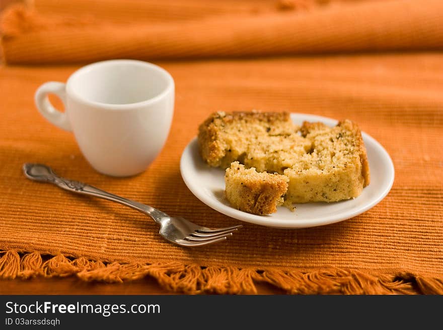 Cake on a saucer and a cup of coffee.