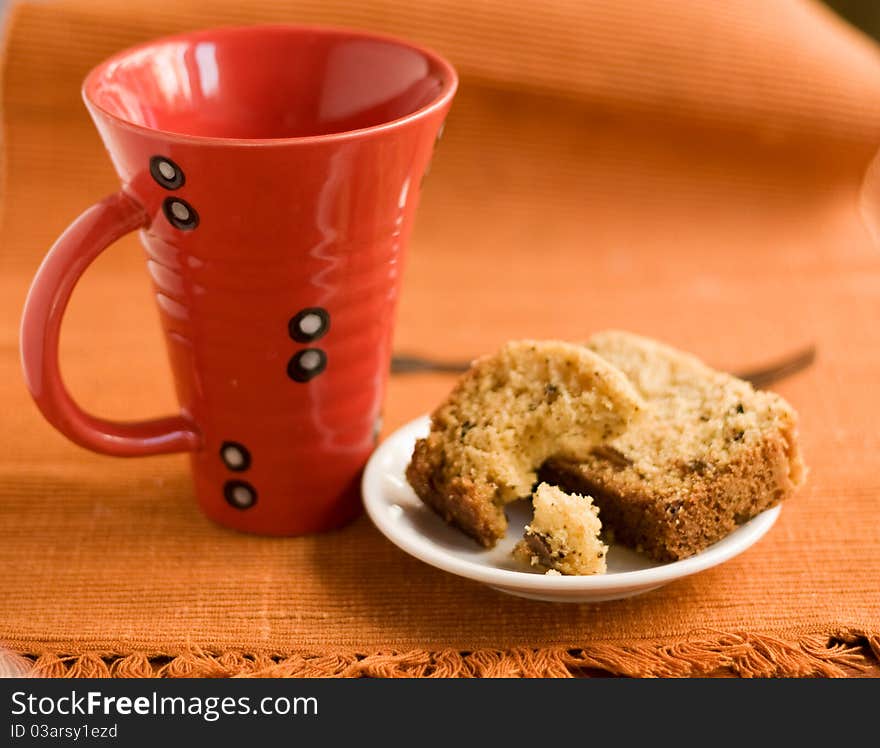 Big red cup and cake on a plate. Big red cup and cake on a plate.