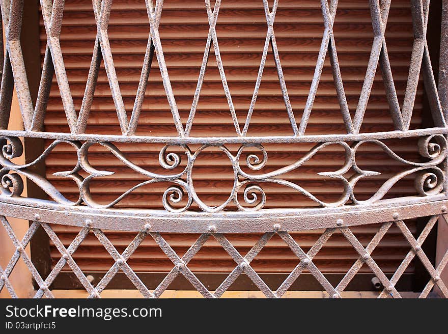 Part of the rusty iron gratings with ornament on the window. Part of the rusty iron gratings with ornament on the window.