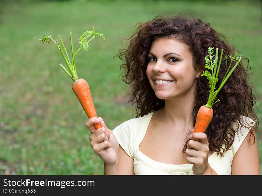 Woman with pair of fresh carrots.