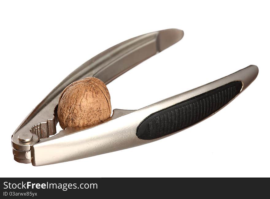 Walnut and a metal nutcracker isolated on white