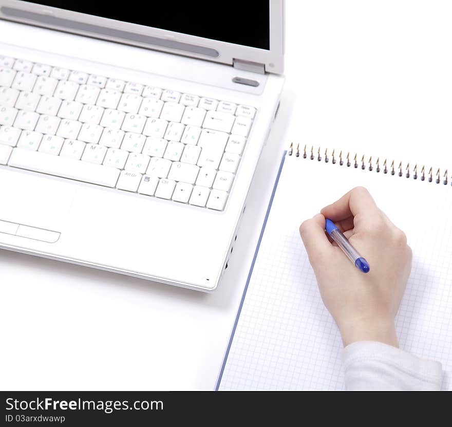 Business notebook with laptop and pen in hand. Studio shot.