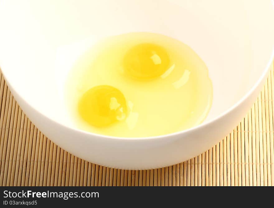 Ingredients for breakfast: eggs in a white bowl