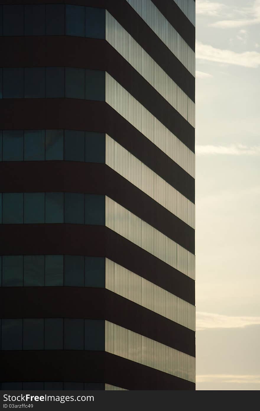 Angled shot of an office building with shiny glass.