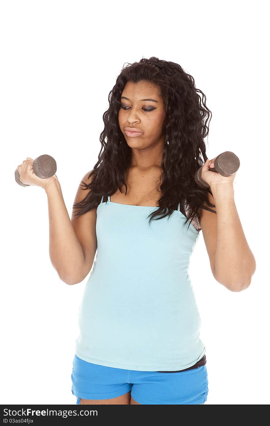 An African American woman is holding a set of weights. An African American woman is holding a set of weights.