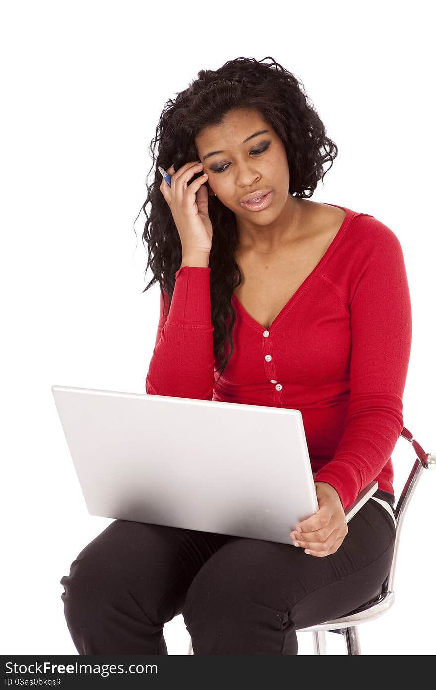 An African American woman is thinking and holding a computer. An African American woman is thinking and holding a computer.