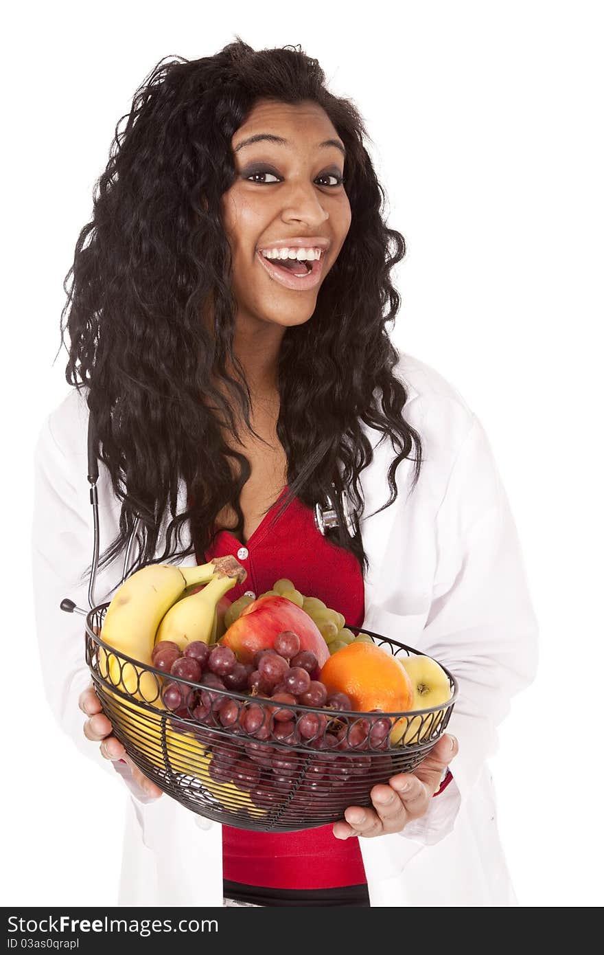 A woman with a stethoscope is holding a fruit basket. A woman with a stethoscope is holding a fruit basket.