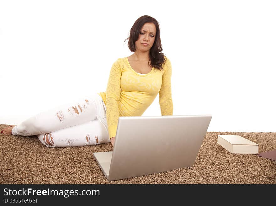 A woman is sitting at a laptop with a funny expression on her face. A woman is sitting at a laptop with a funny expression on her face.