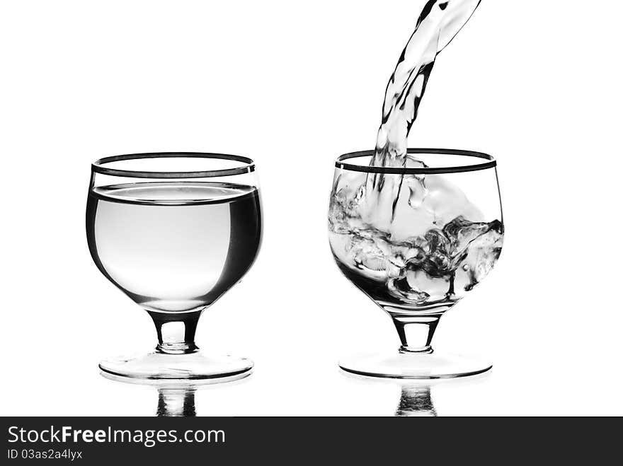 Two wine glasses with liquid. White background. Studio shot. Two wine glasses with liquid. White background. Studio shot.