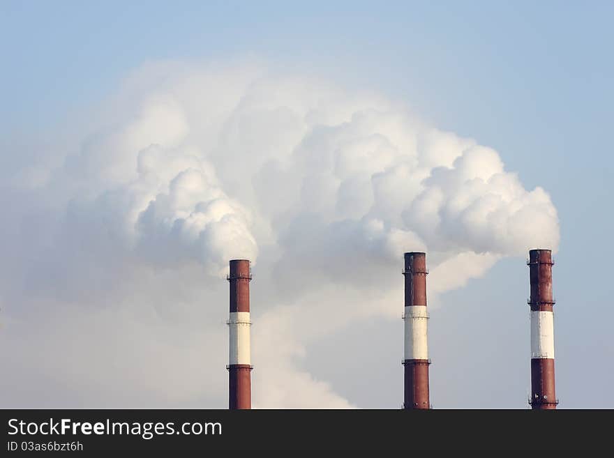 Three smoking chimneys other blue sky