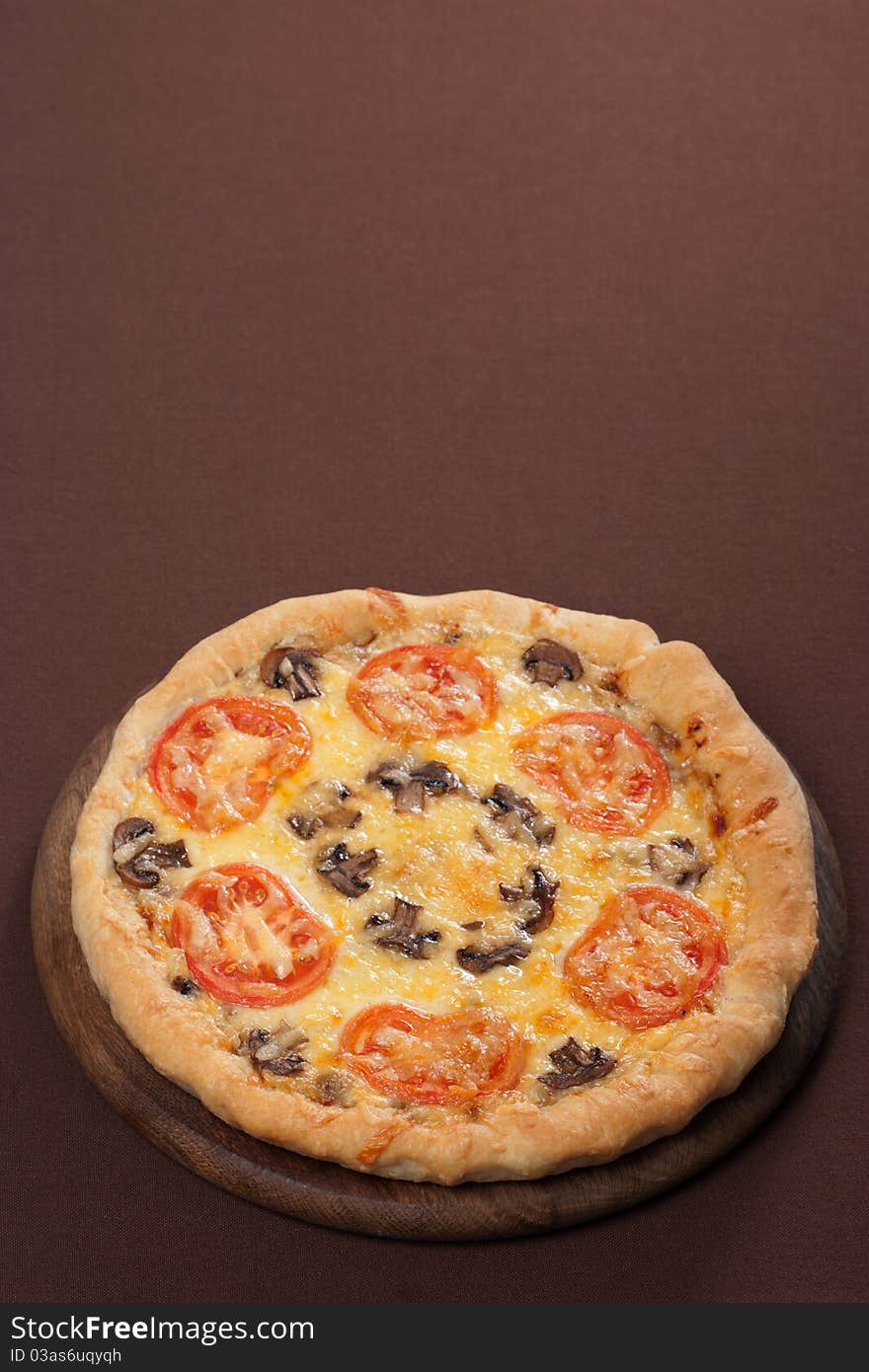 Fresh baked pizza with mushroom and tomatoes