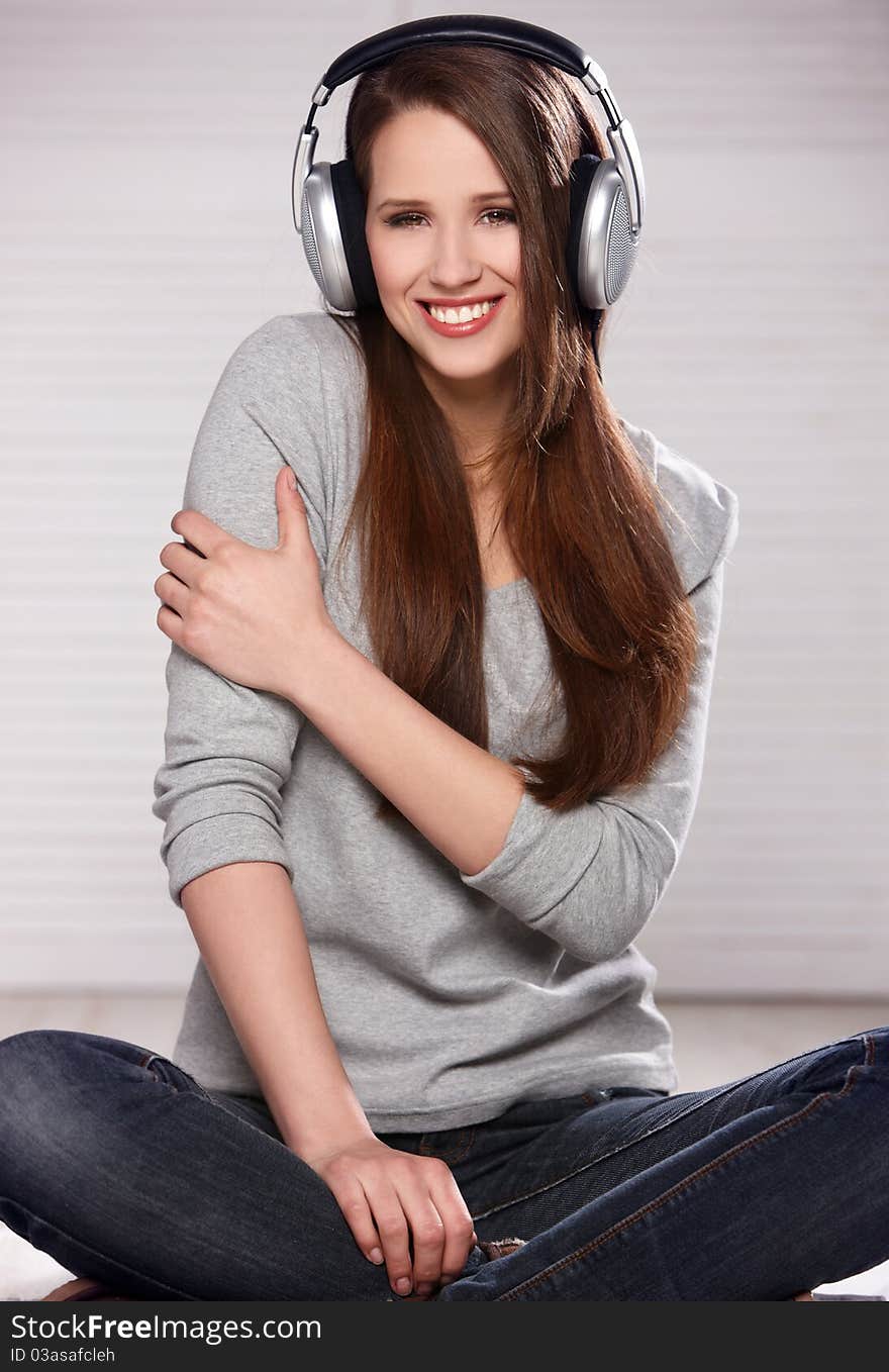 Sweet teenager is listen to the music in headphones. Sweet teenager is listen to the music in headphones