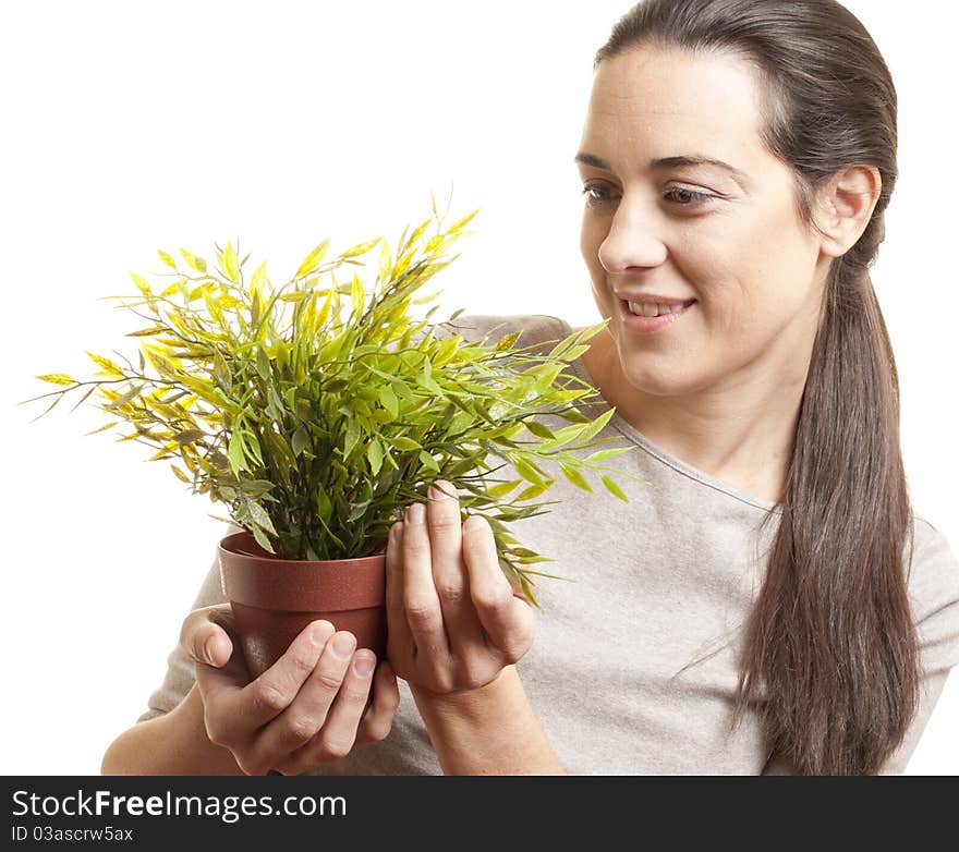 Beautiful woman holding a small plant