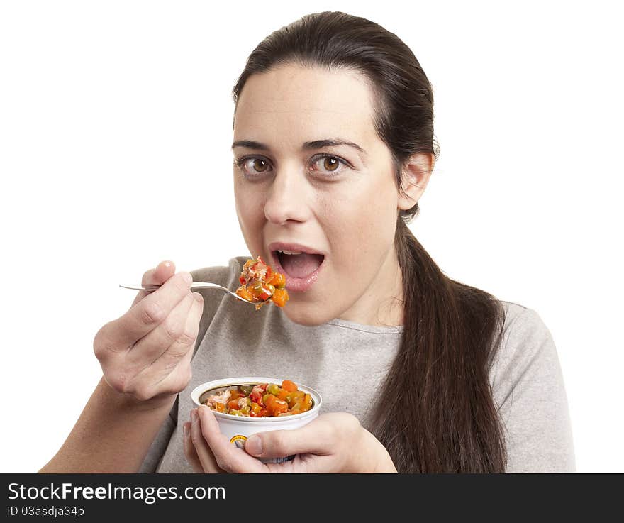 Portrait of young happy woman eating salad isolated on white