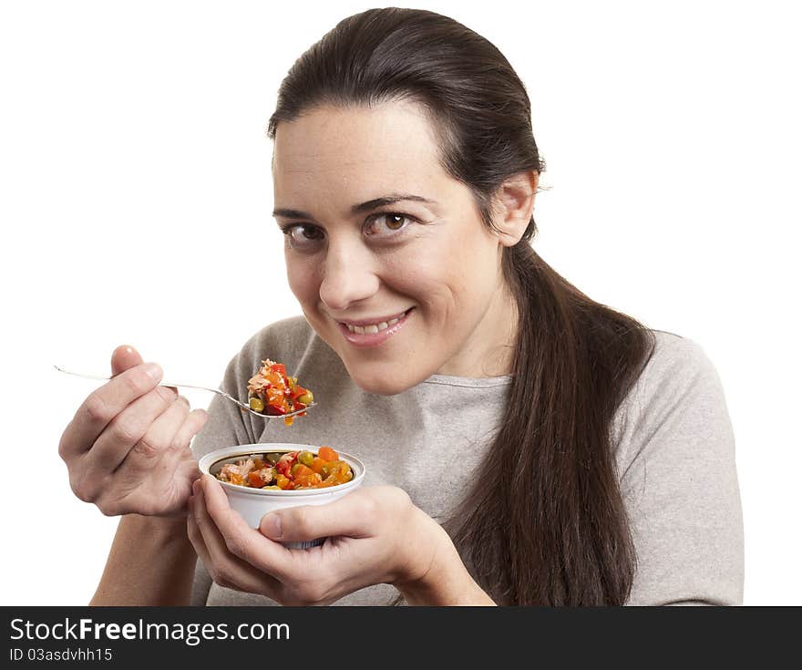 Portrait of young happy woman eating salad