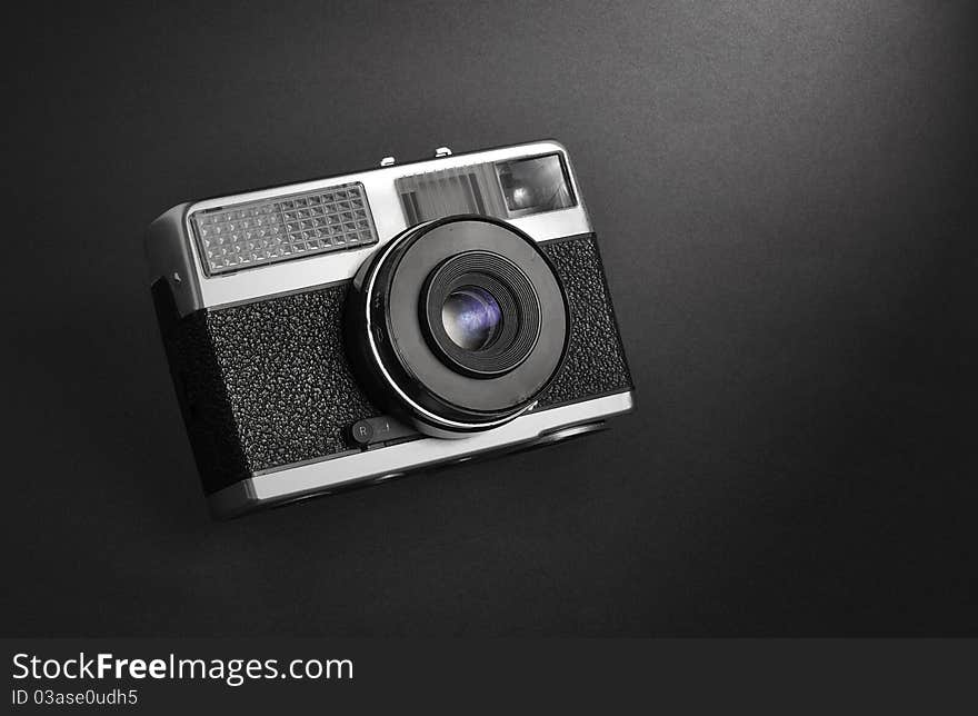 Classic vintage film rangefinder camera isolated on black grainy background. Classic vintage film rangefinder camera isolated on black grainy background