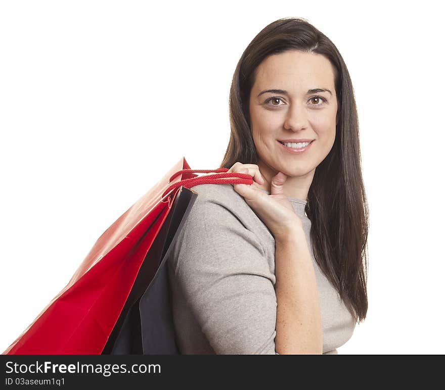 Woman holding shopping bags against a white background. Woman holding shopping bags against a white background