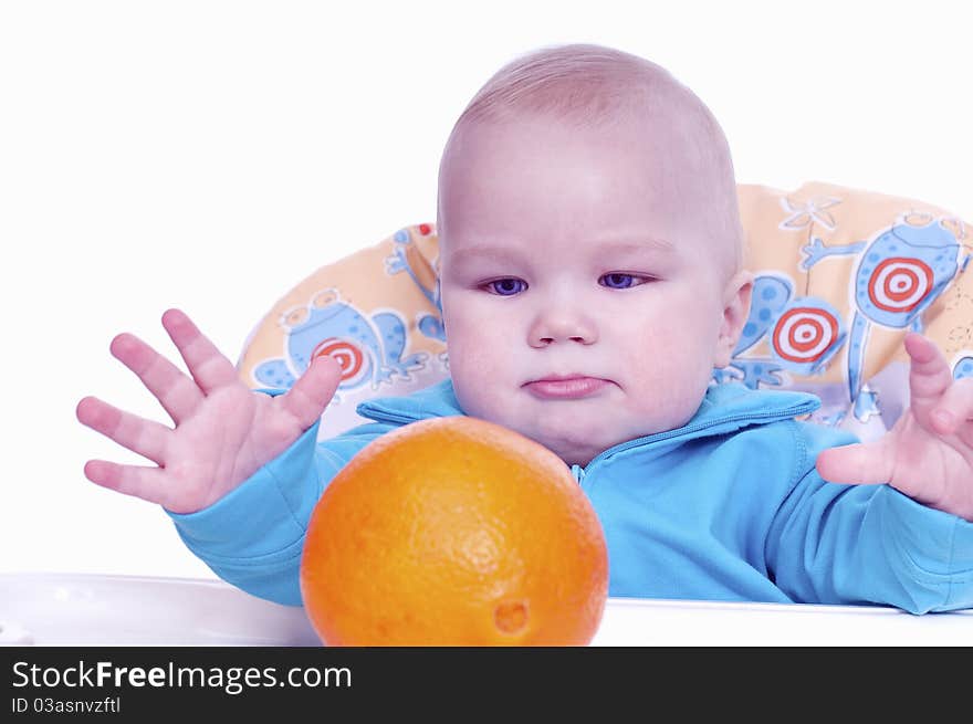 And wants to pick up a large orange on a white background. And wants to pick up a large orange on a white background