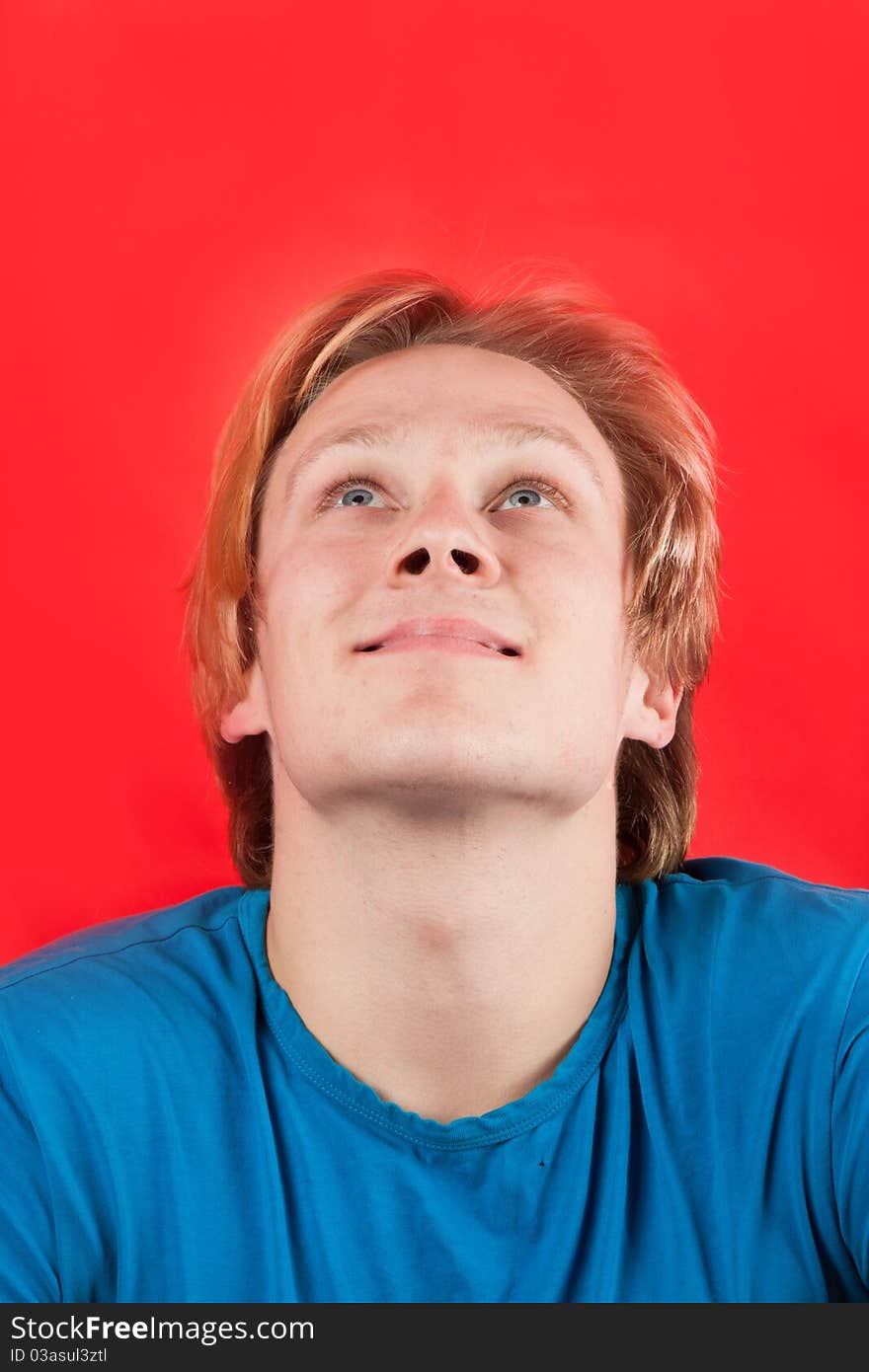 Man looking up at copy-space with red background. Man looking up at copy-space with red background