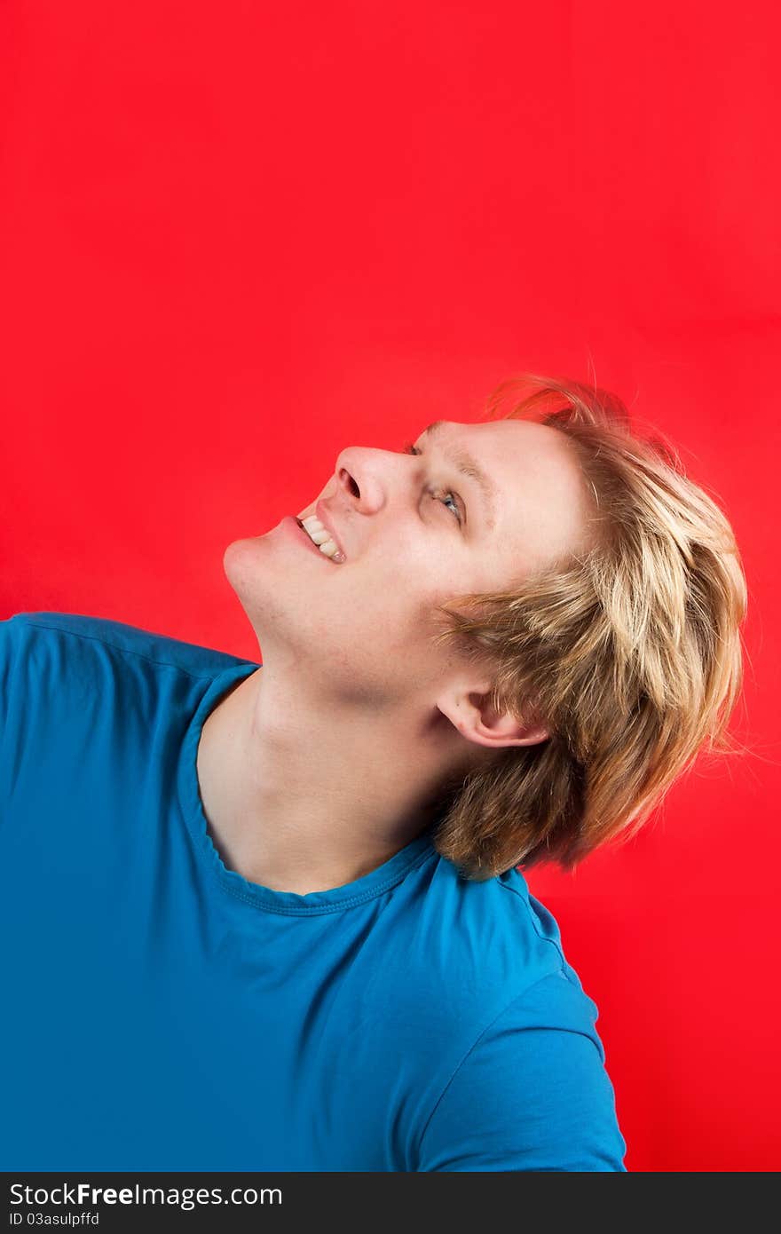 Man looking up at copy-space with red background. Man looking up at copy-space with red background