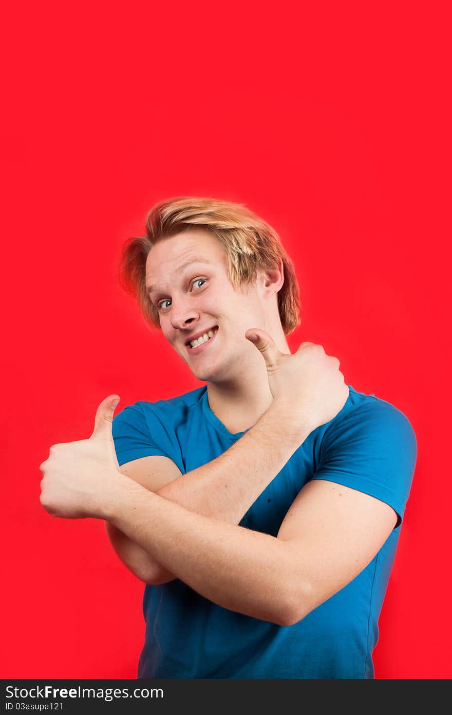 Man doing two thumbs up with red background. Man doing two thumbs up with red background