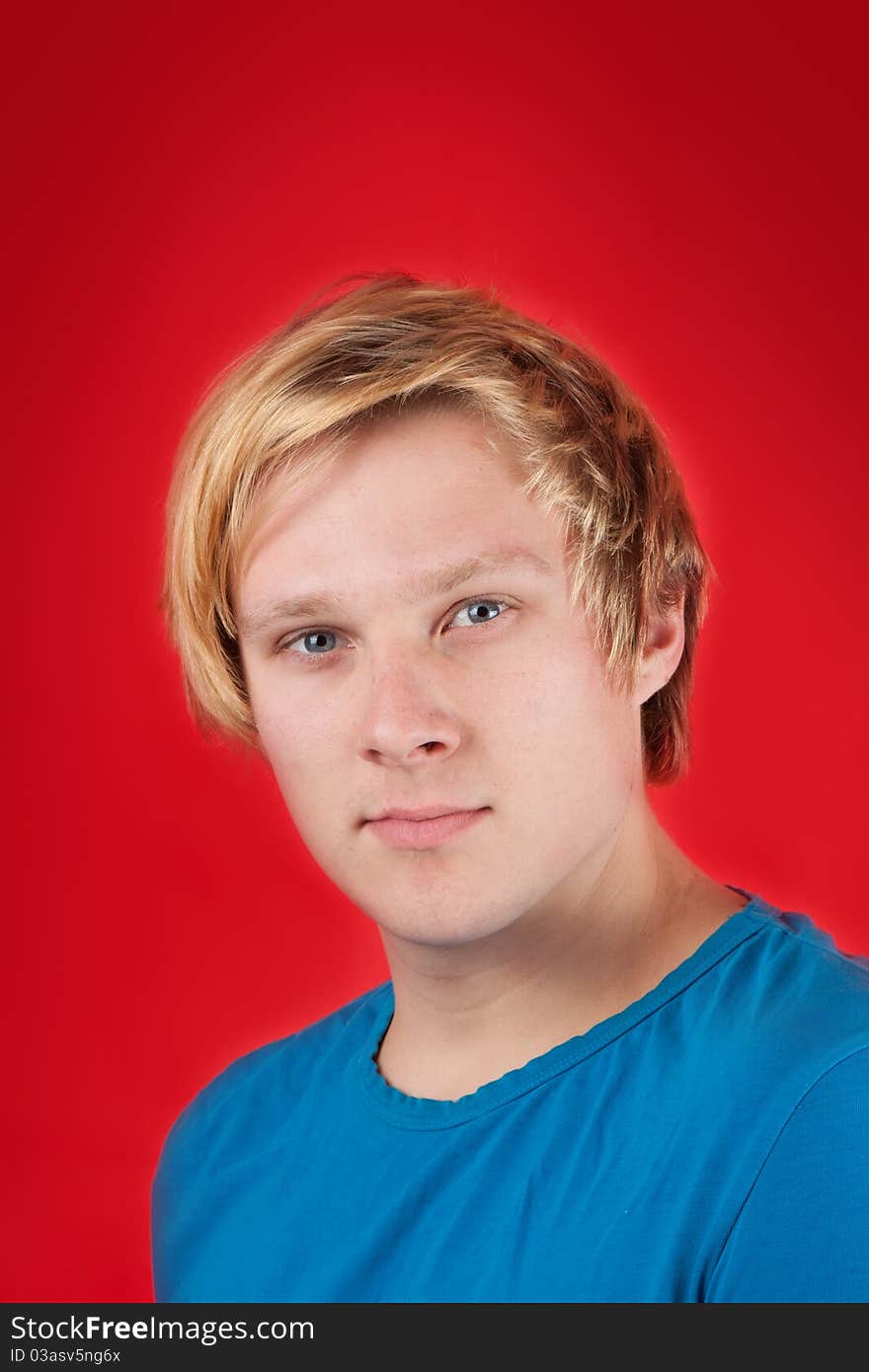 Handsome young man on red background