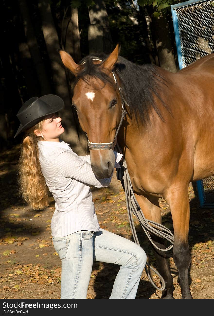 Portrait of young woman with her white horse on the farm yard. Portrait of young woman with her white horse on the farm yard