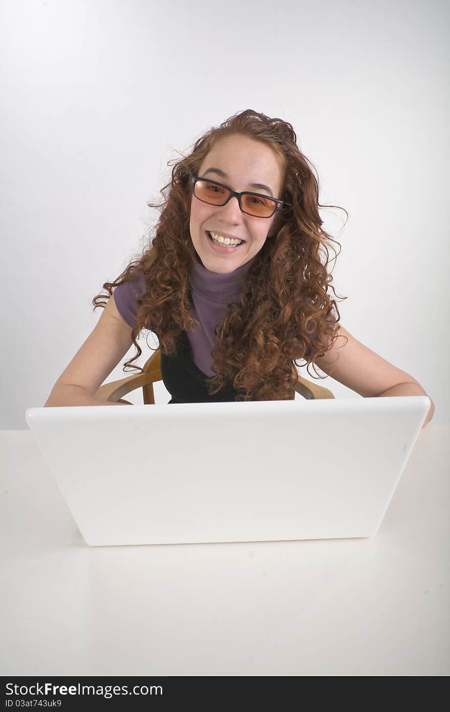 Beautiful teen girl alone with white laptop computer