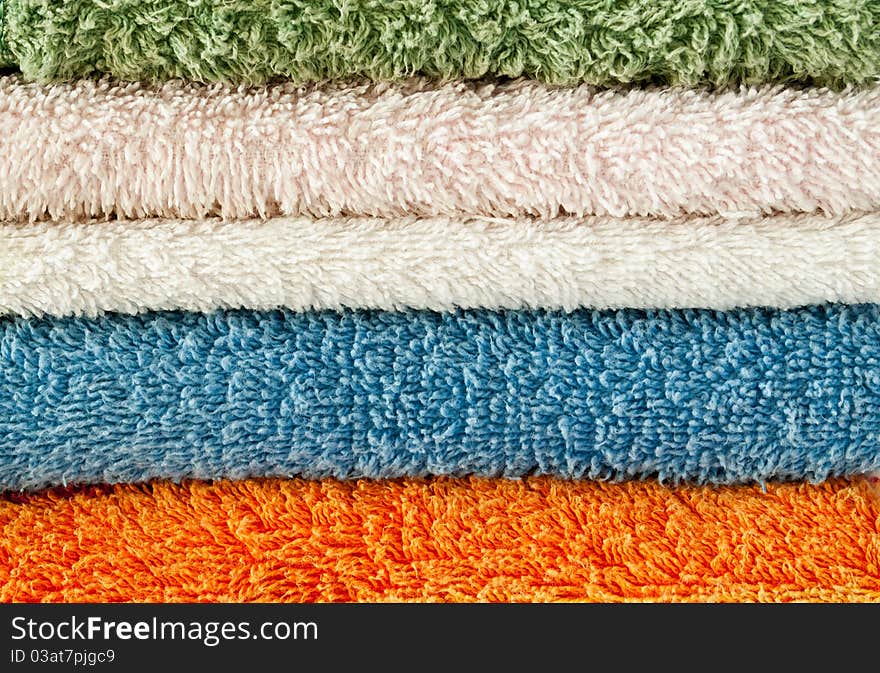 Towels of different colors stacked in a pile